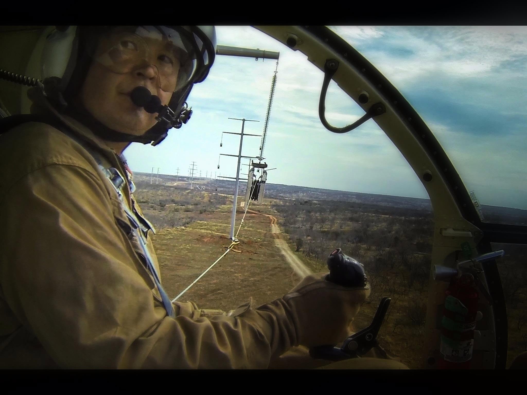 Ken Kuwahara at the controls during a longline operation near power lines